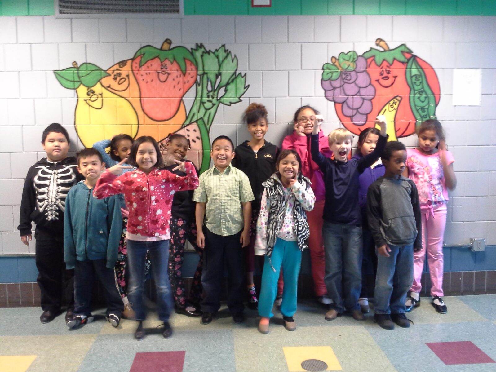 Happy kids posing in front of a wall