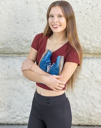 Photo of Ashley holding a pair of tap shoes