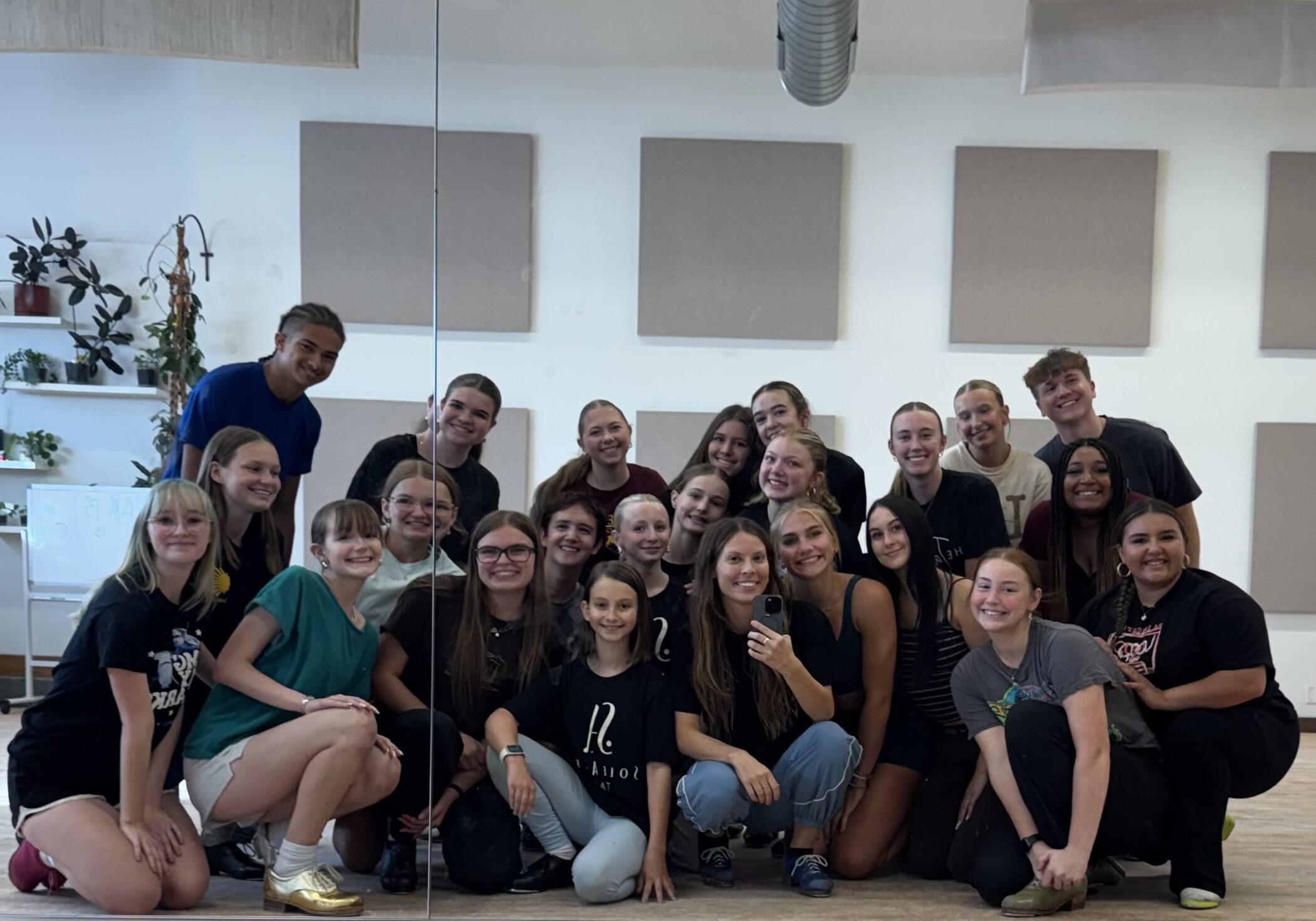 A group of advanced and intermediate/advanced dancers pose for a group photo with their teacher