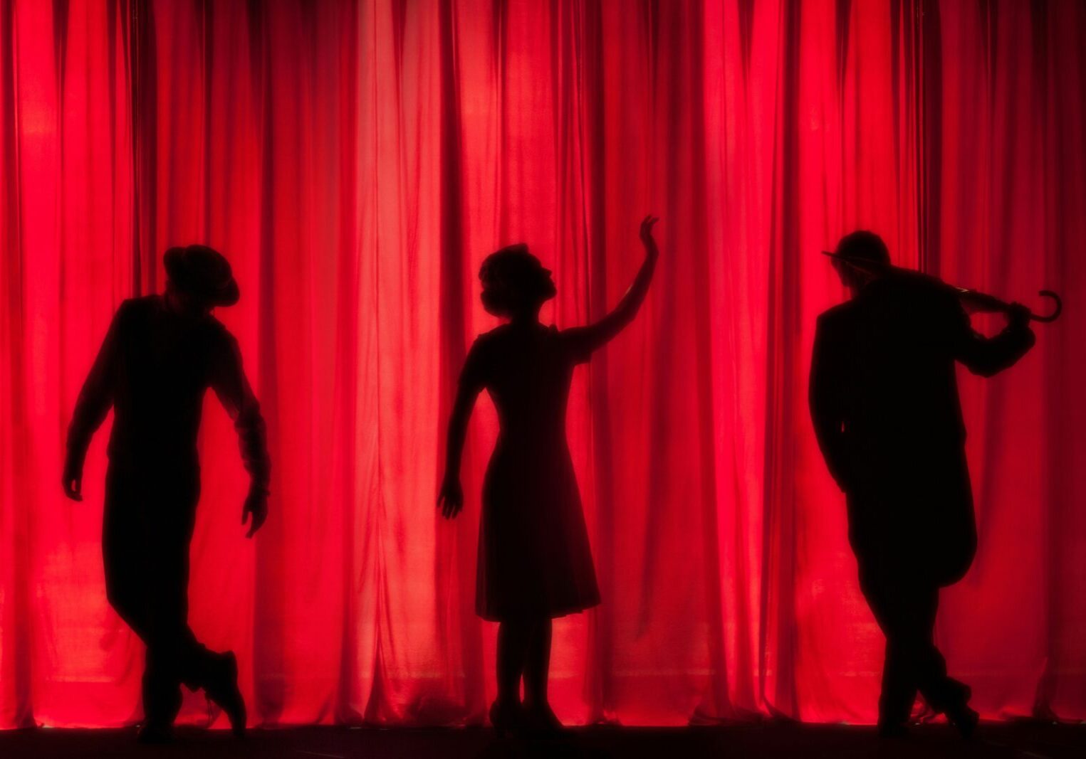 Silhouettes of performers on stage
