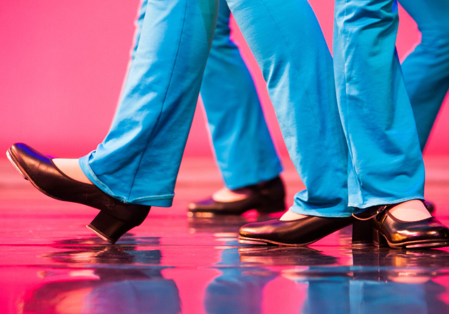 Showing off the feet of adult tap dancers